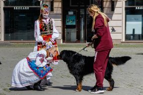 A girl in Hutsul national dress kisses a dog