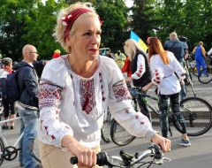 Woman in an embroidered shirt on a bicycle