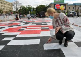 The woman draws an embroidered ornament