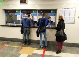 Passengers in masks at the box office at the subway station
