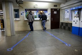 Passengers in masks at the box office at the subway station
