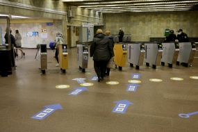 Sticker on the floor near the turnstiles with a call to keep your distance