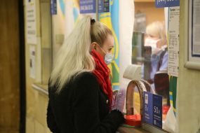 Woman in a medical mask near the subway ticket office