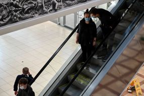 Buyers on the escalator at shopping center in Kyiv