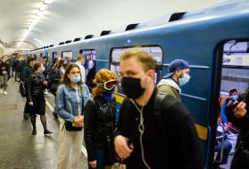 Passengers in medical masks at a metro station