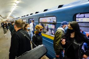 Passengers in medical masks at a metro station
