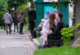 Young couple kisses on a bench