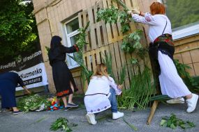 The participants of the action weave a wreath