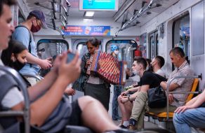Girl playing the accordion in the subway
