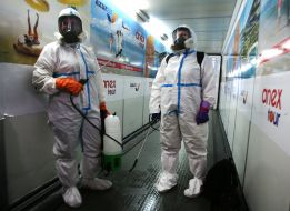 Workers in protective suits