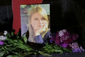 Flowers near the photo of Kateryna Gandziuk