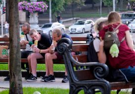 Young people eating sandwiches on the street