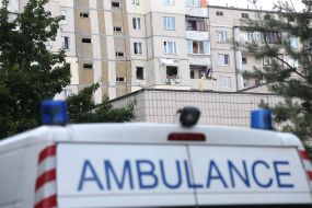 Ambulance near a house damaged in an explosion in Kyiv