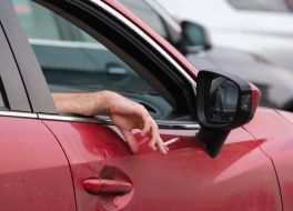 A man holds a cigarette in his hand