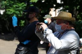 Men in protective masks film the participants of the action
