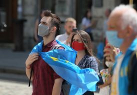 People hold Crimean Tatar flags