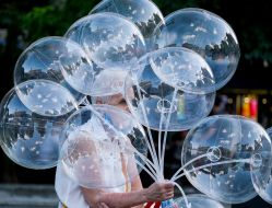 A bystander with balloons