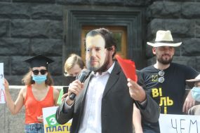 Participant of the action "StopCharlet" in a mask with the image of the Acting Minister of Education and Science Serhiy Shkarlet