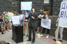 Participant of the action "StopCharlet" in a mask with the image of the Acting Minister of Education and Science Serhiy Shkarlet