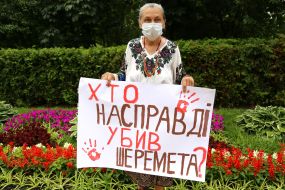 The participant of the action holds a poster