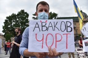 The participant of the action holds a poster