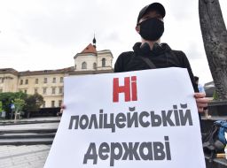 The participant of the action holds a poster