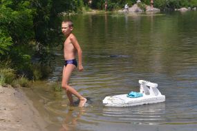 The boy is resting by the river in Zaporozhye