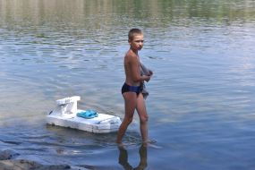 The boy is resting by the river in Zaporozhye