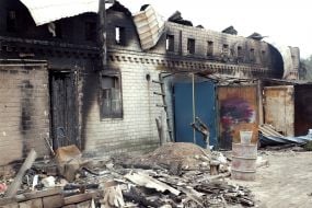 Burnt remains of a house in the village of Smolyaninovo in Luhansk region