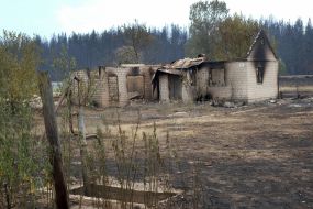 Burnt remains of a house in the village of Smolyaninovo in Luhansk region