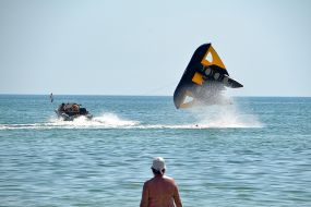 Vacationers ride on the attraction "Batman" in the sea
