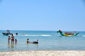 Vacationers ride on the attraction "Dragon"  in the sea