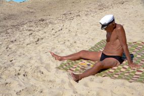 A man sunbathes on the beach