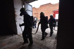 Rescuers extinguish a simulated fire