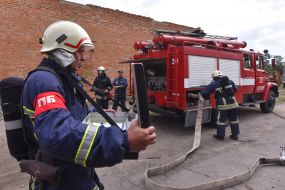 Rescuers extinguish a simulated fire