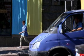A man walks on the sidewalk in Kiev