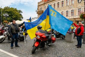 The participants of the motor race hold flags
