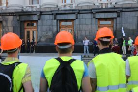 Protesters hold posters