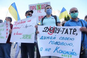 Protesters hold posters