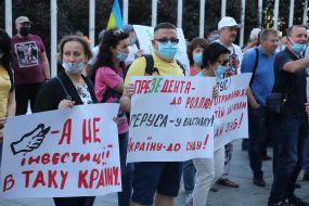 Protesters hold posters