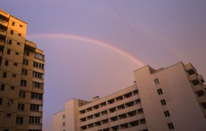 Rainbow over houses in the sky