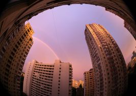Rainbow over houses in the sky