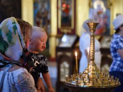 The parishioner puts a candle in St. Michael's Cathedral