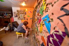 Volunteers weave camouflage suits and nets for the army