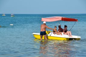 People ride a catamaran in the Black Sea