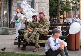 Soldiers rest on a bench