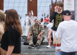 A serviceman is sitting on the stairs