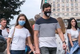 Passers-by walk down the street