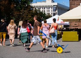 A man drives an empty wheelbarrow