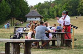 A man in the national Ukrainian costume in the National Museum of Folk Architecture and Life of Ukraine